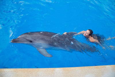 Full length of young woman swimming in sea