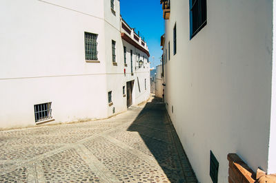 Alley amidst buildings against sky