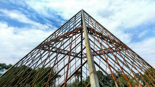 Low angle view of metallic bridge against sky