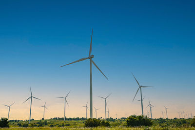 Wind turbine renewable energy source summer with blue sky.