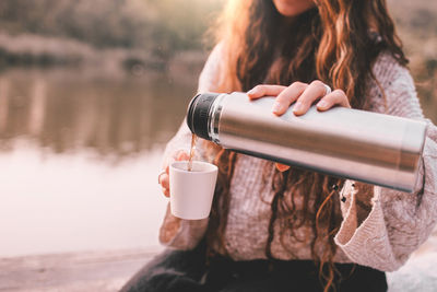 Woman drinking water from coffee