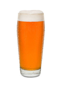 Close-up of beer glass against white background