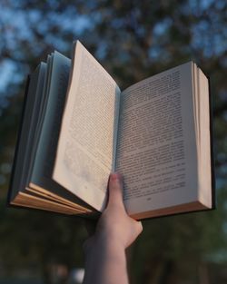 Low section of person holding book