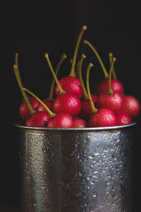 Close-up of cherries in water against black background