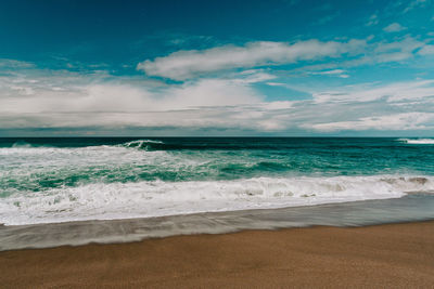 Scenic view of beach against sky