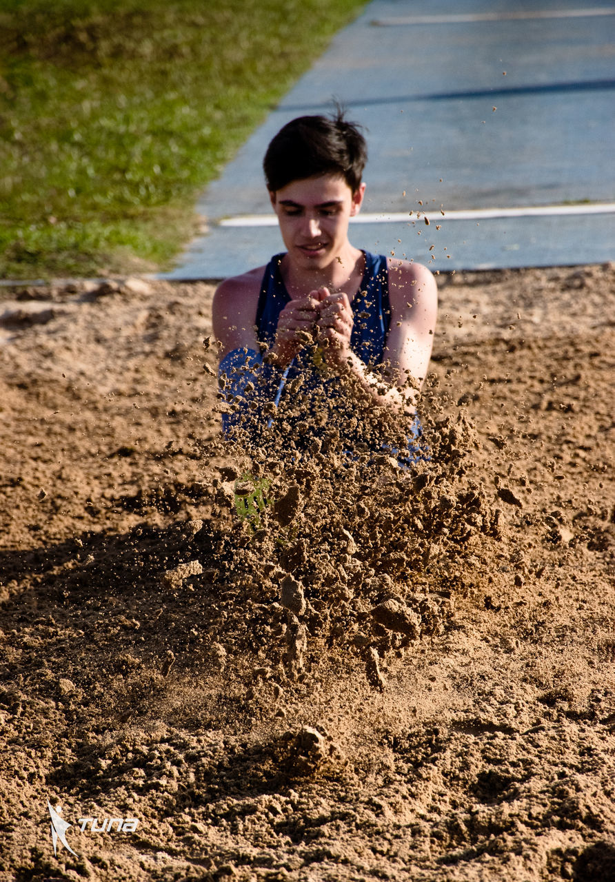 one person, soil, nature, water, adult, land, lifestyles, young adult, front view, sand, sunlight, day, leisure activity, women, portrait, smiling, emotion, outdoors, happiness, dirt, summer, person, mud, beach, casual clothing, child, childhood, female, spring, looking at camera