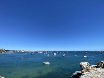 Scenic view of sea against clear blue sky