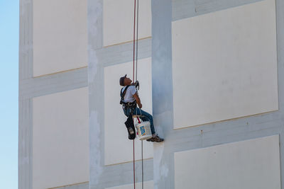 Low angle view of man against building