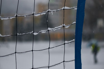 Close-up of barbed wire fence during winter