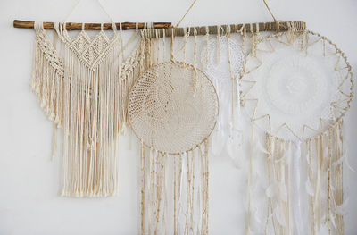 Close-up of decoration hanging against white wall