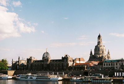 Boats in river with buildings in background