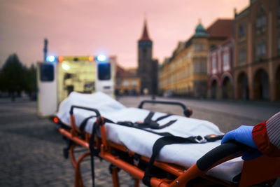 Paramedic preparing stretcher for patient. ambulance car of emergency medical service in city. 