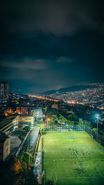 High angle view of illuminated cityscape against sky at night