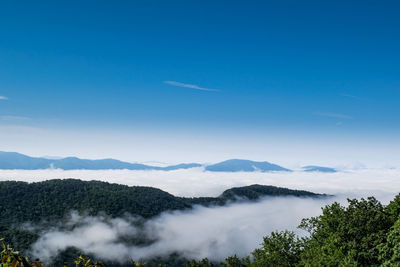 Scenic view of mountains against blue sky