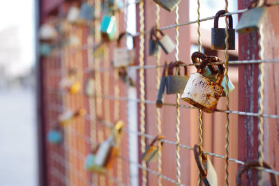 Close-up of rusty padlocks hanging on fence