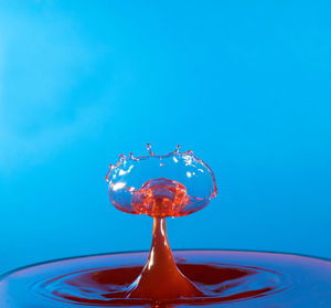 Close-up of water splashing against blue background