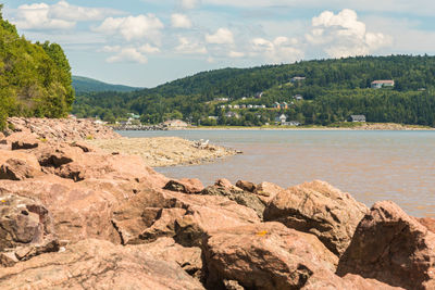 Scenic view of sea and mountains against sky