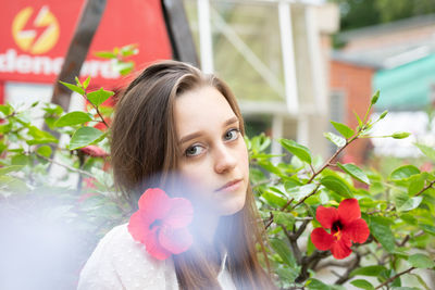 Portrait of woman with red flowers