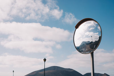 Low angle view of crystal ball against sky