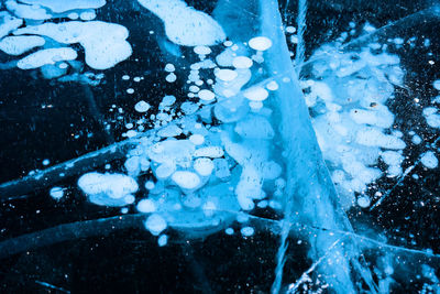 Close-up of frozen water falling from ice