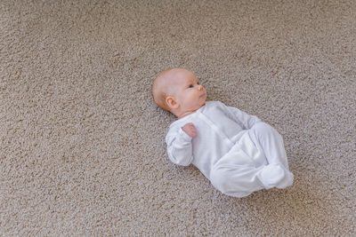 High angle view of baby girl lying on floor