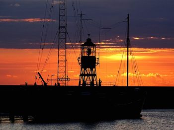 Boats in sea at sunset