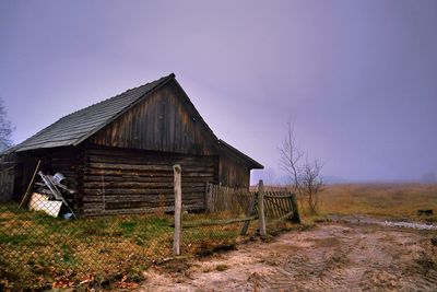 Abandoned house on field against clear sky