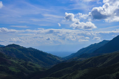 Scenic view of valley and mountains against sky