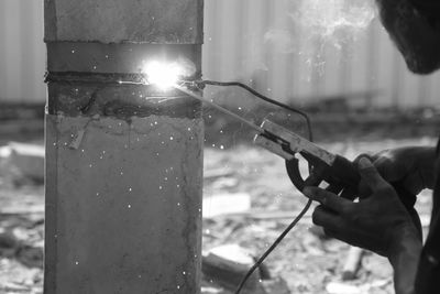 Close-up of person working on glass