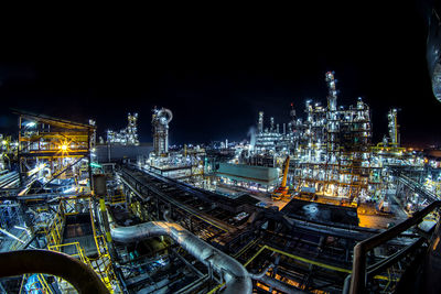 High angle view of illuminated city against sky at night