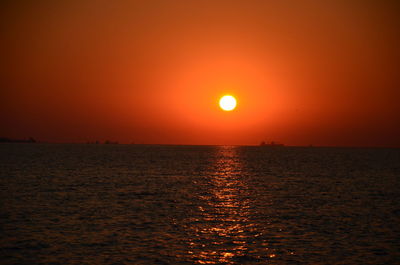Scenic view of sea against orange sky