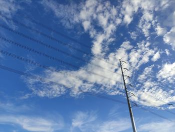 Low angle view of electricity pylon against sky