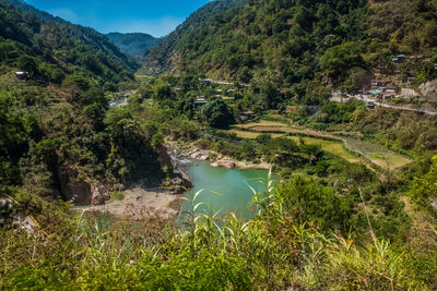 High angle view of river amidst trees against sky