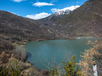 Scenic view of lake and mountains against sky