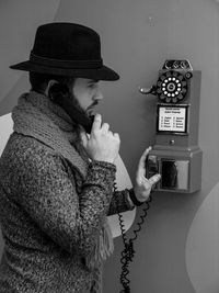 Side view of senior man holding mobile phone