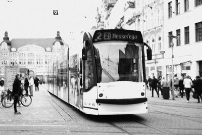 People on street in city against sky