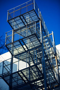 Low angle view of modern building against blue sky