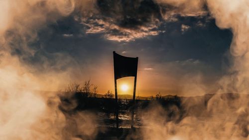 Silhouette built structure against sky during sunset