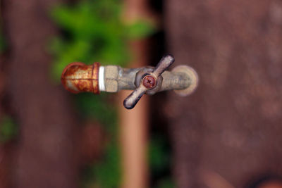 Directly above shot of rusty pipe and faucet