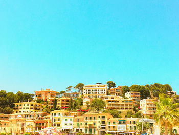 Low angle view of buildings against clear blue sky