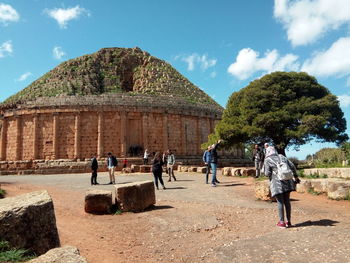 Large group of people by built structure