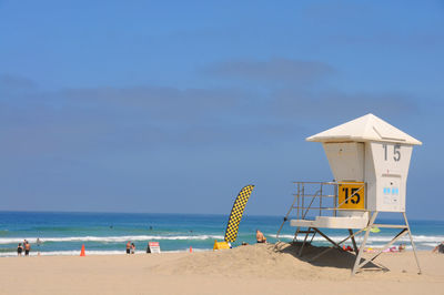 Lifeguard hut at beach against sky