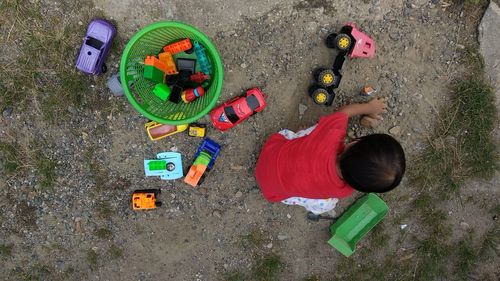 High angle view of children playing with toy on land