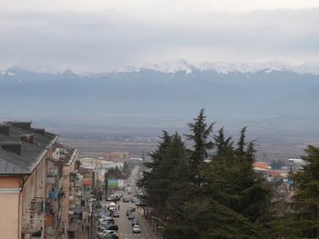 High angle view of townscape and mountains against sky