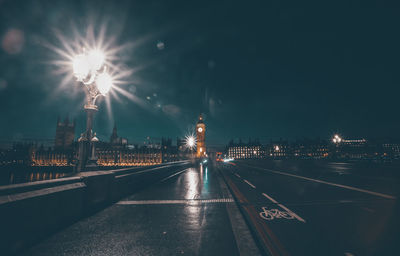 Illuminated city against sky at night