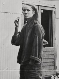 Portrait of woman standing against wall