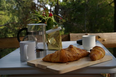 Croissants on cutting board over table