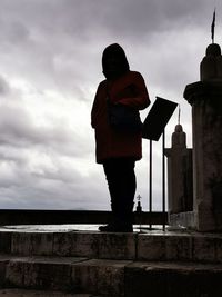 Low angle view of man standing against building