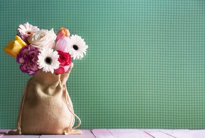 Close-up of flowers in sack on table