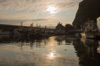 Boats in marina at sunset